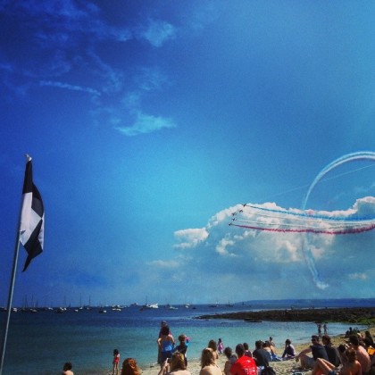 The Red Arrows draw large crowds over Gylly Beach, Falmouth, Cornwall